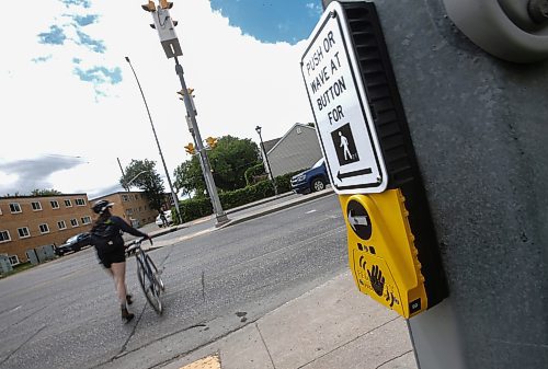 JOHN WOODS / FREE PRESS
People use a new crosswalk at St Mary and Carrier Monday, June 24, 2024. The city has added lights and time at several crosswalks.

Reporter: joyanne