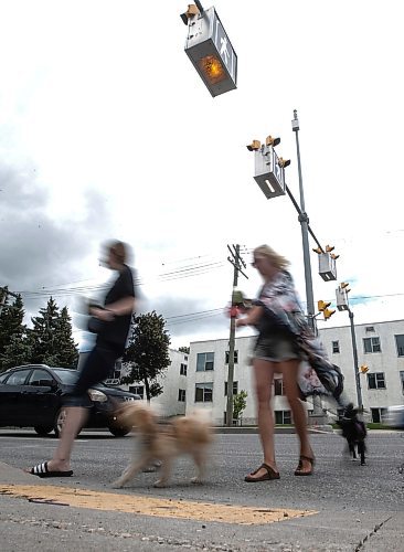 JOHN WOODS / FREE PRESS
People use a new crosswalk at St Mary and Carrier Monday, June 24, 2024. The city has added lights and time at several crosswalks.

Reporter: joyanne