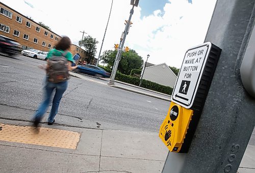 JOHN WOODS / FREE PRESS
People use a new crosswalk at St Mary and Carrier Monday, June 24, 2024. The city has added lights and time at several crosswalks.

Reporter: joyanne