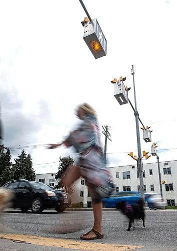 JOHN WOODS / FREE PRESS
People use a new crosswalk at St Mary and Carrier Monday, June 24, 2024. The city has added lights and time at several crosswalks.

Reporter: joyanne