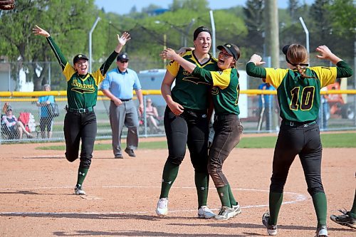 Boissevain Broncos pitcher Danika Nell, centre, is embraced by teammate McKenna Beard after winning high school fast pitch provincials in 2022. (Brandon Sun files)