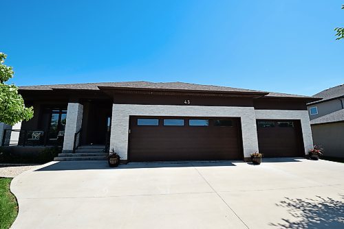 Todd Lewys / Free Press
This home's tremendous appeal starts with a beautifully landscaped yard, an elegant stone exterior and a covered entry with front porch.
