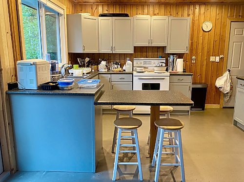 Marc LaBossiere / Free Press
The tired wood-grain finish of the old cabinets that fought with the tongue-and-groove pine wall paneling now updated to a muted grey, solid shaker-style finish greatly improving the look and feel of the kitchen space.