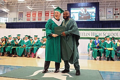 Graduate Zachary Chambers laughs while receiving his diploma from principal Baseswa Nundu. (Tim Smith/The Brandon Sun)