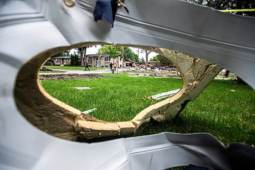 MIKAELA MACKENZIE / FREE PRESS

The rubble where a house exploded yesterday (as seen through the front door, which landed in a yard across the street) on Camrose Bay in Transcona on Thursday, June 27, 2024.

For &#x460;story.

