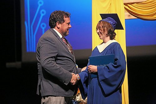 Prairie Hope High School student Jessica Land receives the Glen Simard MLA Award from the Brandon East MLA himself during a graduation ceremony at the Western Manitoba Centennial Auditorium on Thursday afternoon. (Matt Goerzen/The Brandon Sun)