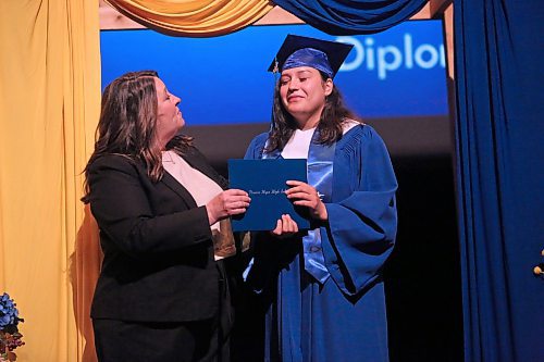 Fighting back tears, Prairie Hope High School student Ashley Happyjack Pompana accepts her graduation diploma from school principal Katherine MacFarlane on Thursday afternoon at the Western Manitoba Centennial Auditorium. (Matt Goerzen/The Brandon Sun)