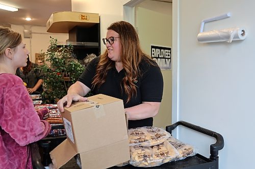 Brandon Food Rescue Grocery Store's retail lead, Elizabeth Morrow unboxes a new shipment of chicken nuggets from Maple Leaf Foods at the store on Friday afternoon. (Geena Mortfield/The Brandon Sun)