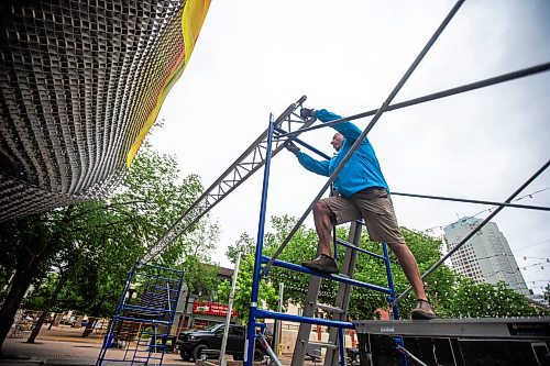 MIKAELA MACKENZIE / FREE PRESS

Michael Lysohirka, sound tech for the Soca Reggae Festival, sets up the stage at Old Market Square in the rain on Friday, June 28, 2024. The performances for Friday night were moved indoors, but the weekend is expected to go as planned.

Standup.

