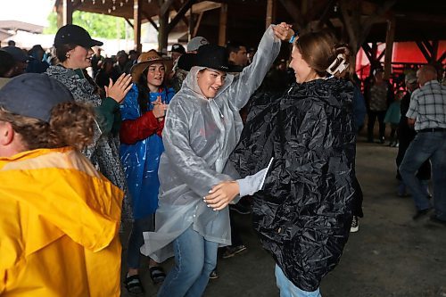 28062024
Festival-goers dance to the music of Quinton Blair during Dauphin&#x2019;s Countryfest on a wet Friday afternoon. (Tim Smith/The Brandon Sun)