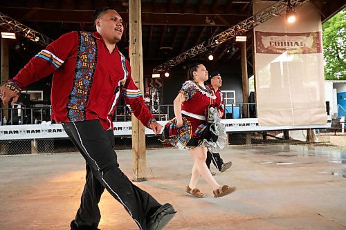 28062024
Siblings Mikey Harris, Cieanna Harris and Jacob Harris, known collectively as the Ivan Flett Memorial Dancers, perform during Dauphin&#x2019;s Countryfest on a wet Friday afternoon. (Tim Smith/The Brandon Sun)