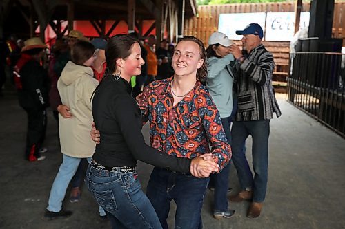 28062024
Halle Dupre and Bryce Dubek of Arborg, Manitoba two-step to the music of Quinton Blair during Dauphin&#x2019;s Countryfest on a wet Friday afternoon. (Tim Smith/The Brandon Sun)