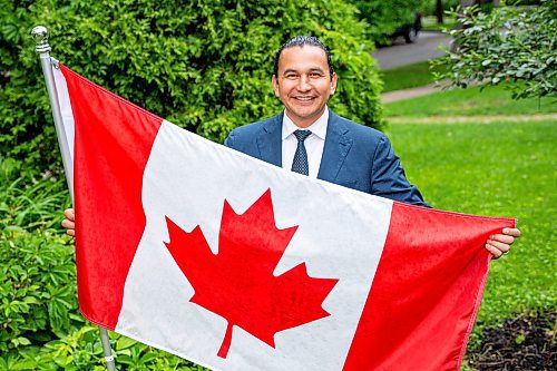 NIC ADAM / FREE PRESS
Premier Wab Kinew outside his house with the Canadian flag he purchased and installed after his trip to Normandy.
240628 - Friday, June 28, 2024.

Reporter: Carole Sanders