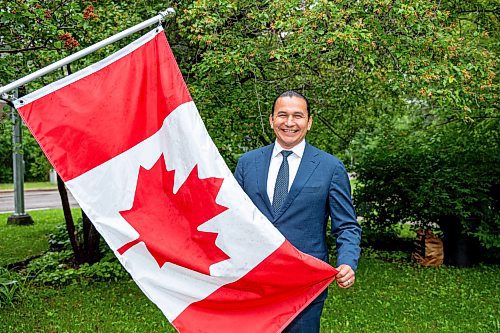 NIC ADAM / FREE PRESS
Premier Wab Kinew outside his house with the Canadian flag he purchased and installed after his trip to Normandy.
240628 - Friday, June 28, 2024.

Reporter: Carole Sanders