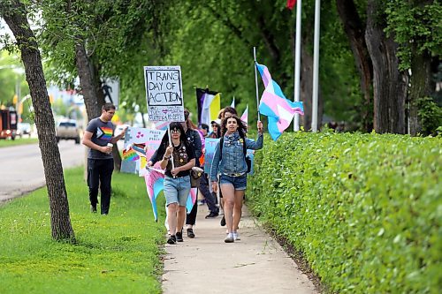 Rudy Wilder (left) holds up a sign and Leila Praznik (right) waves a transgender flag as they lead Brandon's first Trans Day of Action march past Brandon University on 18th St. on Saturday morning. (Colin Slark/The Brandon Sun)