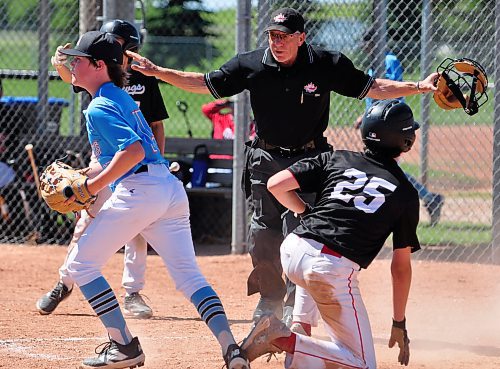 Veteran umpire Pete Perreault calls Okotoks Dawgs Academy base runner Owen Reed (25) safe at the plate after be beat the tag applied by 13U AAA Brandon Marlins starting pitcher Austin Stratiluk (left) at Simplot Field on Day 2 of the Canada Day Triple Crown Showdown. (Jules Xavier/The Brandon Sun)