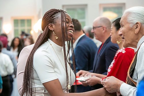 BROOK JONES / FREE PRESS
A CanadIan citizenship ceremony was hosted on Canada Day at the Pavilion at Assiniboine Park in Winnipeg, Man., Monday, July 1, 2024. Pictured: Oreo Amogu, 31, (left) is all smiles as she shakes hands with Elder Winston Wuttunee after she took the oath of citizenship. Amogu and her husband Henry Amogu, who also took the oath of citizenship, immigrated from Nigeria to Canada.