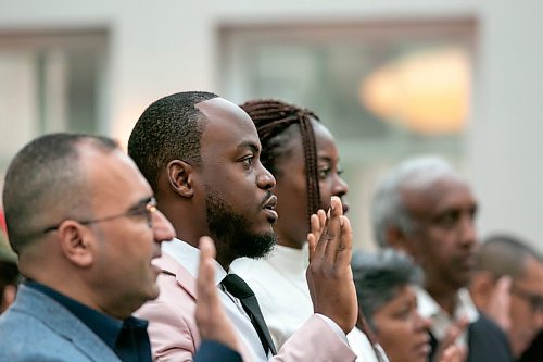 BROOK JONES / FREE PRESS
A CanadIan citizenship ceremony was hosted on Canada Day at the Pavilion at Assiniboine Park in Winnipeg, Man., Monday, July 1, 2024. Pictured: Henry Amogu, 31, (middle) participates in the oath of Cctizenship with his wife Oreo Amogu, 31, (right).. The couple immigrated from Nigeria to Canada. Also pictured is Hussam Alhaddad, 50, (left) who immigrated to Canada from Iraq.