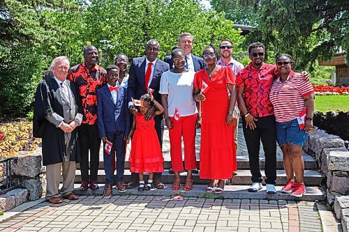 The Dada family from Nigeria and their friends pose with Dwight Macaulay (left), honorary consul of the United Kingdom, who administered the oath of citizenship, Turtle Mountain MLA Doyle Piwniuk (middle rear) and International Peace Garden executive director Tim Chapman (right rear). (Charlotte McConkey/The Brandon Sun)