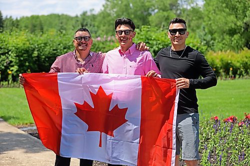 Gilberto Segovia and his sons Justin and Bryan Segovia hold the Canadian flag after being sworn in as citizens at a ceremony that took place on Canada Day at the International Peace Garden. (Charlotte McConkey/The Brandon Sun)