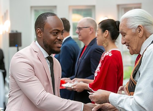 BROOK JONES / FREE PRESS
A CanadIan citizenship ceremony was hosted on Canada Day at the Pavilion at Assiniboine Park in Winnipeg, Man., Monday, July 1, 2024. Pictured: Henry Amogu, 31, (left) shakes hands with Elder Winston Wuttunee after he took the oath of citizenship. Amogu and his wife Orea Amogu, who also took the oath of citizenship, immigrated from Nigeria to Canada.