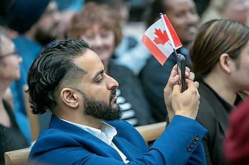 BROOK JONES / FREE PRESS
A CanadIan citizenship ceremony was hosted on Canada Day at the Pavilion at Assiniboine Park in Winnipeg, Man., Monday, July 1, 2024. Pictured: Gurpreet Singh (left) shakes hands with Elder Winston Wuttunee after he took the oath of citizenship. Pictured: Kanav Sharma, 31, waves a Canadian flag as he takes a photo.