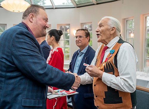 BROOK JONES / FREE PRESS
A CanadIan citizenship ceremony was hosted on Canada Day at the Pavilion at Assiniboine Park in Winnipeg, Man., Monday, July 1, 2024. Pictured: Daryl Bisset left), 59, who immigrated to Canada from Zimbabwe, shakes hands with Elder Winston Wuttunee after he took the oath of citizenship.