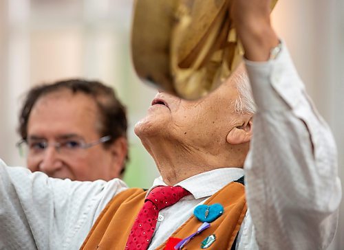 BROOK JONES / FREE PRESS
A CanadIan citizenship ceremony was hosted on Canada Day at the Pavilion at Assiniboine Park in Winnipeg, Man., Monday, July 1, 2024. Pictured: Elder Winston Wuttunee (right) looks up as he performs a drum song at the beginning of the citizenship ceremony while MP for Charleswood-St. James-Assiniboia-Headingley Marty Morantz (left) looks on.