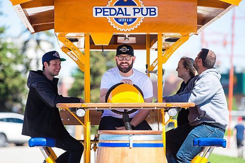 MIKAELA MACKENZIE / WINNIPEG FREE PRESS

Pedal Pub co-owner Miguel Gauthier (driver, centre) demonstrates the rig, along with co-owner Brandon Gauthier (left), general manager Randi Davreux, and co-owner Rylan Adam, at a launch event in downtown Winnipeg on Wednesday, June 1, 2022. The party bike service, which will tour breweries, restaurants, and pubs, is the first of its kind in Winnipeg. For Gabby story.
Winnipeg Free Press 2022.