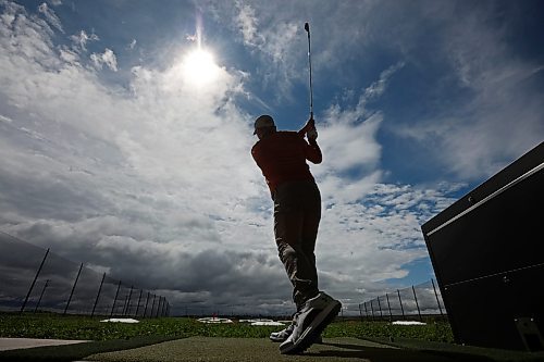 Riley Parker hits the ball at Shanks Driving Range & Grill on a warm Tuesday morning. (Tim Smith/The Brandon Sun)