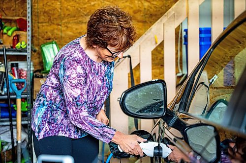 NIC ADAM / FREE PRESS
Electric vehicle owner Shelley Kowalchuck shows press how to pulg in her car in her home on Tuesday.
240702 - Tuesday, July 02, 2024.

Reporter: Martin Cash