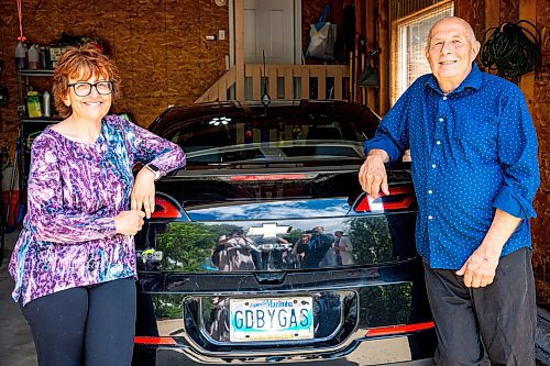 NIC ADAM / FREE PRESS
Shelley Kowalchuck (left) and Gary Pedersen, two electric vehicle owners, pose in front of their Chevrolet Volt in the garage of their home Tuesday.
240702 - Tuesday, July 02, 2024.

Reporter: Martin Cash