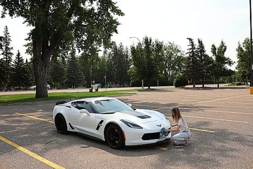 04072024
Haley Foxton polishes her 2018 Corvette Grand Sport in the parking lot of Landmark Cinemas on Thursday, scrubbing off the bugs from her highway travels. Foxton was debating taking in the Downtown Cruise Night with her car. 
(Tim Smith/The Brandon Sun)