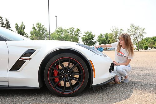 04072024
Haley Foxton polishes her 2018 Corvette Grand Sport in the parking lot of Landmark Cinemas on Thursday, scrubbing off the bugs from her highway travels. Foxton was debating taking in the Downtown Cruise Night with her car. 
(Tim Smith/The Brandon Sun)