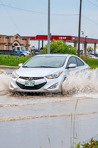 NIC ADAM / FREE PRESS
Cars struggle along a flooded Brookside Blvd, just south of Inkster Blvd, after the thunderstorm on Thursday afternoon.
240704 - Thursday, July 04, 2024.

Reporter: