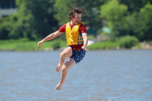 Will Preston is launched through the air into the cool water of Minnedosa Lake while enjoying a hot Friday afternoon with friends at the Splish Splash Water Park. With temperatures sitting in the mid-20s C across western Manitoba, it was the perfect day for outdoor fun. (Tim Smith/The Brandon Sun)