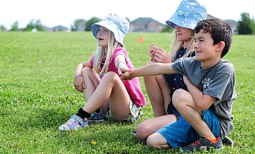 Ruth Bonneville / Free Press

LOCAL - summer camp

Kids signed up with the City of Winnipeg's, What&#x573; Up Camp, (6-12 years) at Island Lakes School enjoying playing hot-dog tag, four square, helping each other climb the play structure and making new friends in their first week of  their summer holidays, Thursday. 

Kids make friends while playing games on the grass outside the school Thursday. 

July 4th,  2024

