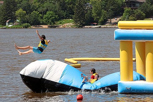 05072024
Cash Coleman is launched through the air into the cool water of Minnedosa Lake by friends Will Preston and Cael Furtney while the friends enjoy a hot Friday afternoon at the Splish Splash Water Park on the lake.
(Tim Smith/The Brandon Sun)