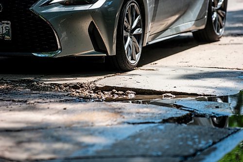 MIKAELA MACKENZIE / FREE PRESS

A car drives around a pothole on Campbell Street (between Academy Road and Wellington Crescent) on Monday, July 8, 2024. 

For Joyanne story.

