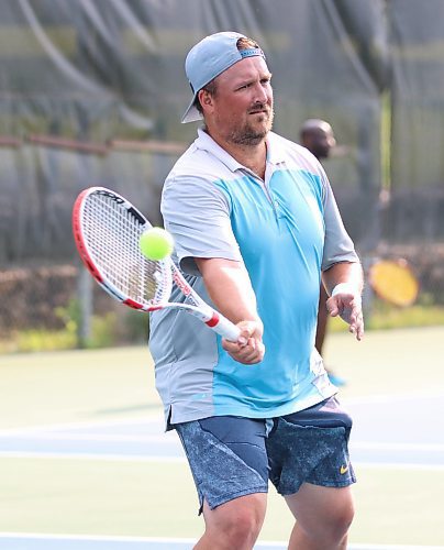 Andrew Arksey returns a volley during a game of doubles at the Wheat City Tennis Club last week. He has reached the national level as an official in the sport. (Perry Bergson/The Brandon Sun)