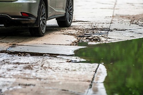 MIKAELA MACKENZIE / FREE PRESS

A car drives around a pothole on Campbell Street (between Academy Road and Wellington Crescent) on Monday, July 8, 2024. 

For Joyanne story.

