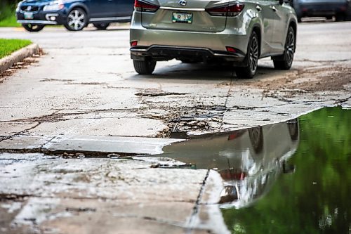 MIKAELA MACKENZIE / FREE PRESS

A car drives around a pothole on Campbell Street (between Academy Road and Wellington Crescent) on Monday, July 8, 2024. 

For Joyanne story.

