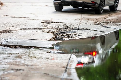 MIKAELA MACKENZIE / FREE PRESS

A car drives around a pothole on Campbell Street (between Academy Road and Wellington Crescent) on Monday, July 8, 2024. 

For Joyanne story.

