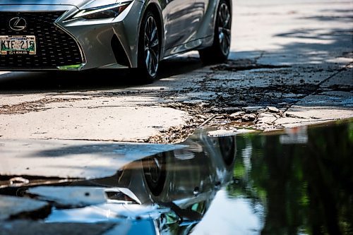 MIKAELA MACKENZIE / FREE PRESS

A car drives around a pothole on Campbell Street (between Academy Road and Wellington Crescent) on Monday, July 8, 2024. 

For Joyanne story.

