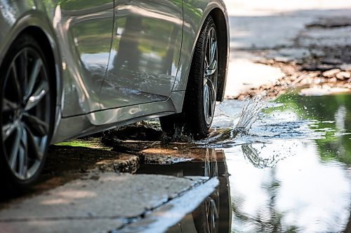 MIKAELA MACKENZIE / FREE PRESS

A car drives around a pothole on Campbell Street (between Academy Road and Wellington Crescent) on Monday, July 8, 2024. 

For Joyanne story.

