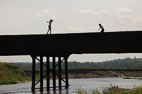 08072024
Siblings Leighton and Cale Calcut stand on the Daly - Whitehead Centennial Bridge while swimming in the Little Saskatchewan River on a hot Monday afternoon. 
(Tim Smith/The Brandon Sun)