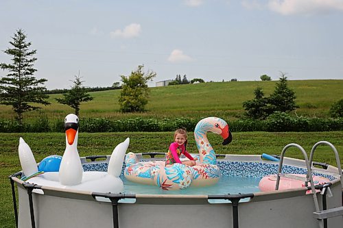 Six-year-old Penelope Reilly-Brady floats on an inflatable flamingo in her family’s above-ground pool at their home northwest of Alexander on Tuesday afternoon. A daytime high of 31 C is forecast for today. (Tim Smith/The Brandon Sun)