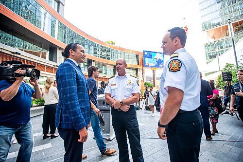 MIKAELA MACKENZIE / FREE PRESS

Premier Wab Kinew (left) chats with WFPS chief Christian Schmidt and deputy chief Ryan Sneath after an announcement on improving downtown safety at a press conference at True North Square on Tuesday, July 9, 2024. 

For Chris story.

