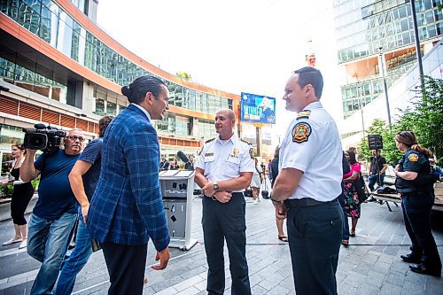 MIKAELA MACKENZIE / FREE PRESS

Premier Wab Kinew (left) chats with WFPS chief Christian Schmidt and deputy chief Ryan Sneath after an announcement on improving downtown safety at a press conference at True North Square on Tuesday, July 9, 2024. 

For Chris story.

