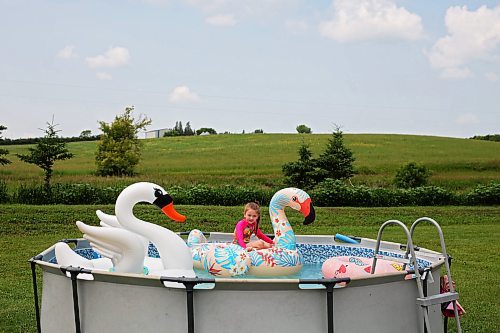 09072024
Six-year-old Penelope Reilly-Brady floats on an inflatable flamingo in her family&#x2019;s above-ground pool at their home northwest of Alexander on a hot Tuesday afternoon. (Tim Smith/The Brandon Sun)